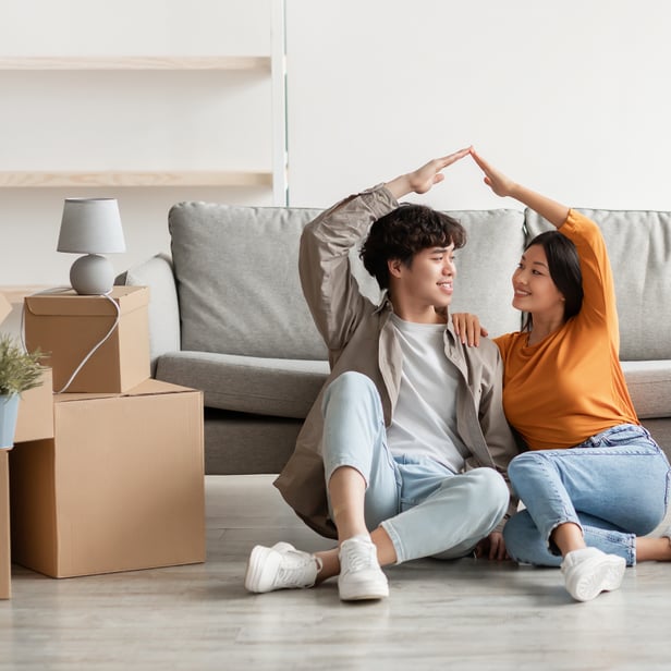 A young couple with arm heart pose